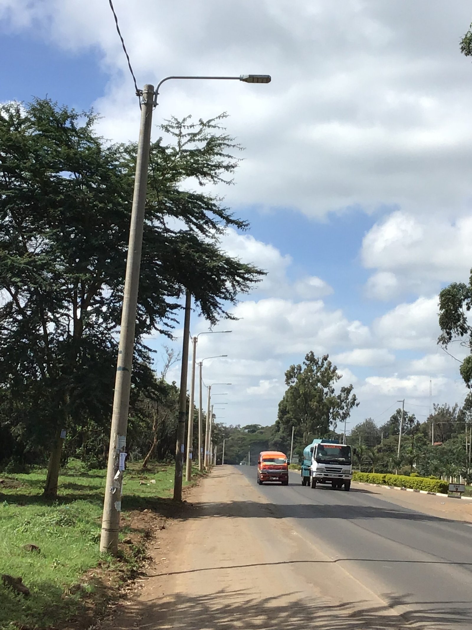 Engineering team installing durable LED street lighting in Kenya