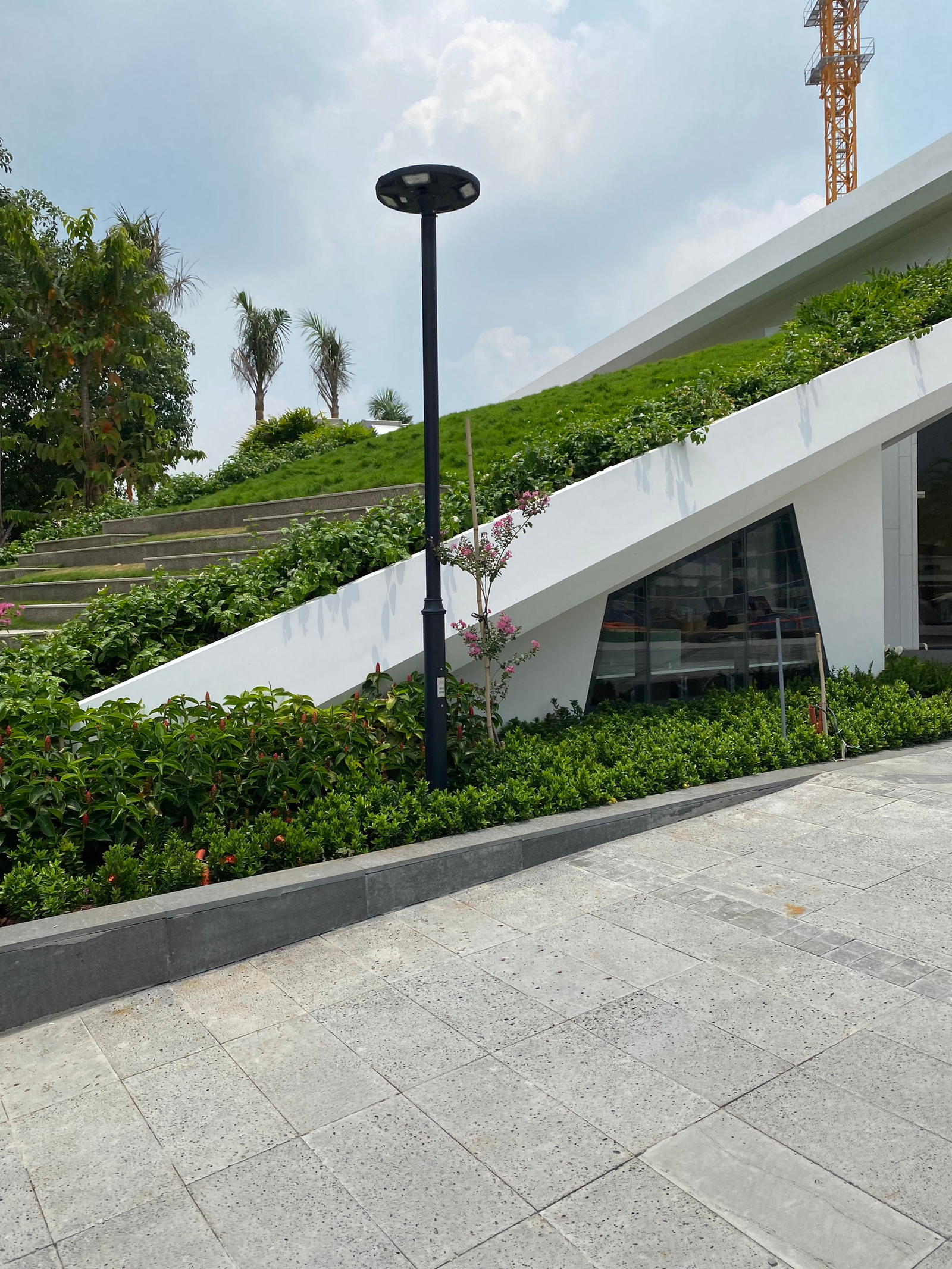 Modern geometric architecture illuminated by sleek solar plaza lighting in Vietnam