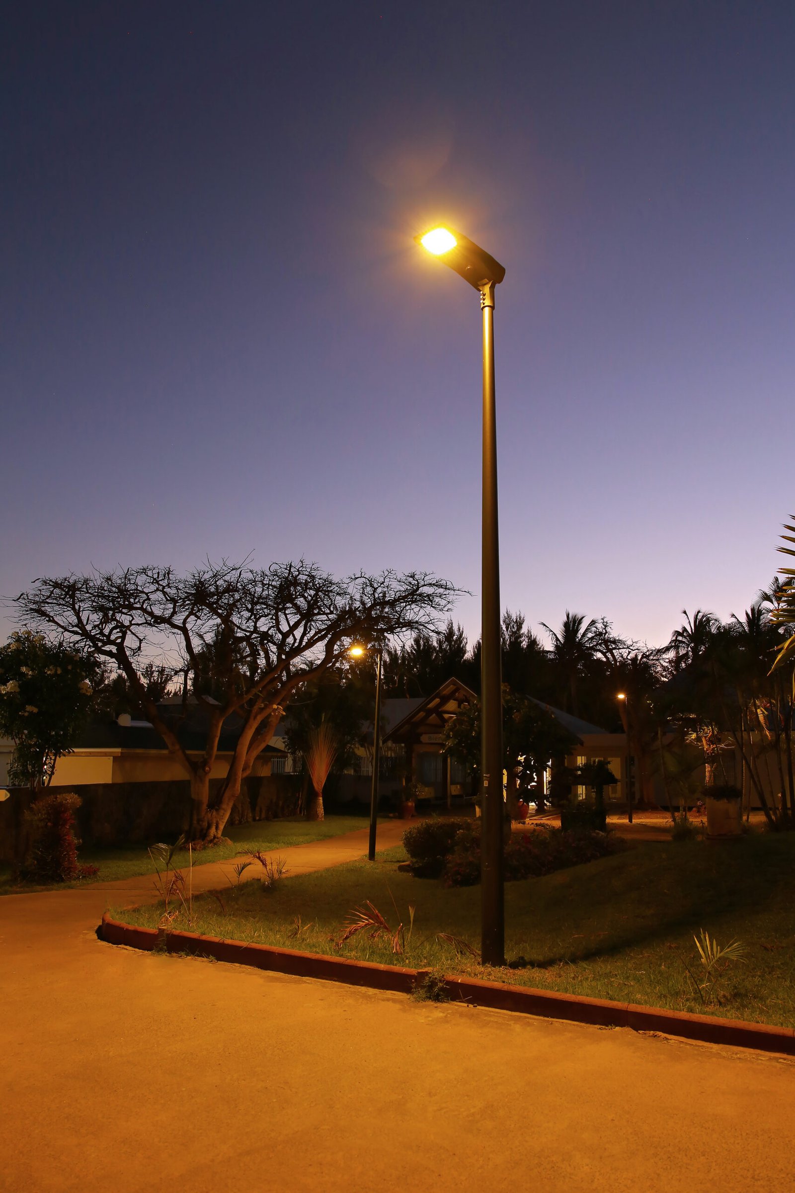 Close-up of modern solar light pole design against a blue twilight sky
