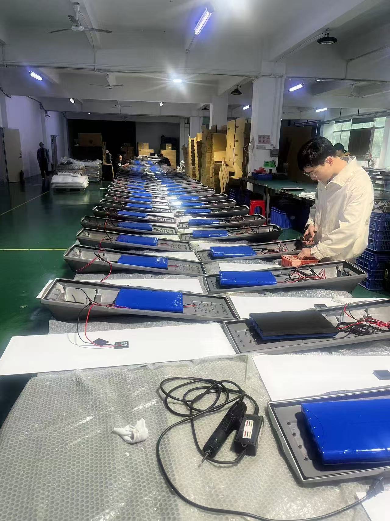 Solar street light production line showing battery installation
